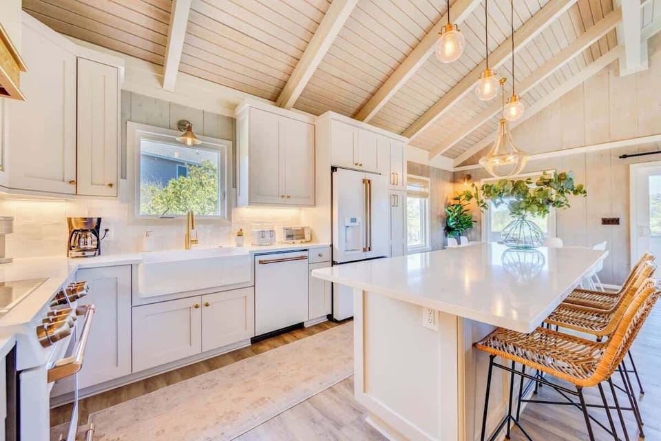 Renovated kitchen with quartz countertops, high-end appliances, and ample space for entertaining.