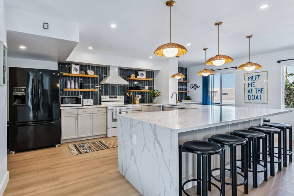 Enjoy a fully equipped kitchen with modern appliances and plenty of space to gather around the island for 10.