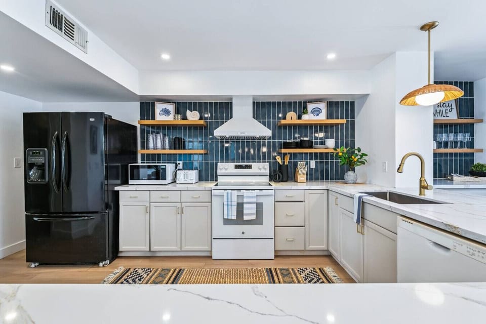 Fully stocked with all the essentials, featuring a Keurig + drip coffee combo and an island that seats 10.