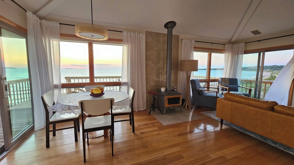 Sunset-lit living with wraparound lake views.