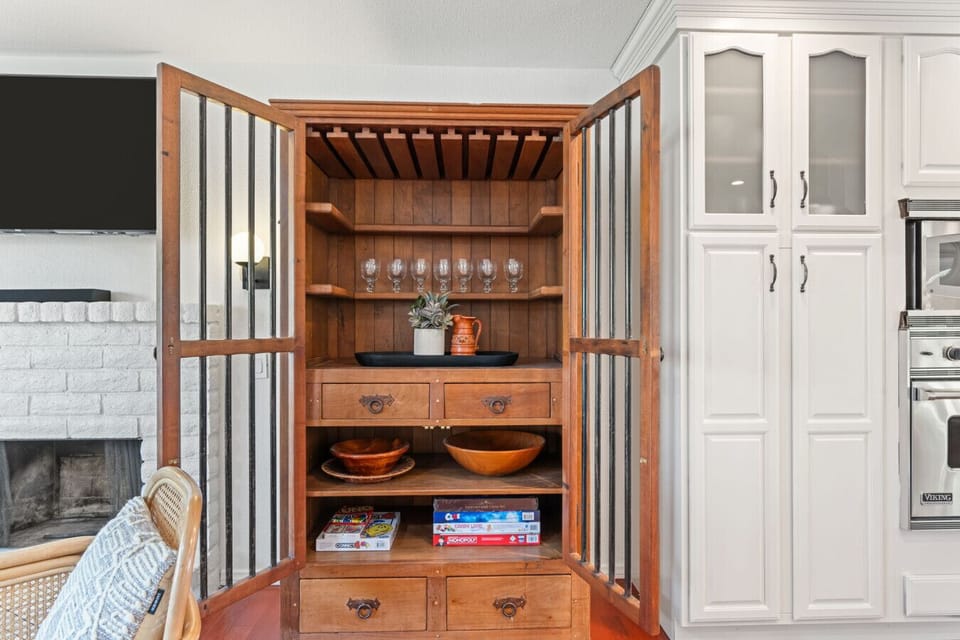 Built-in cabinet w/ TV, storage & games, adding a fun touch to downtime indoors.