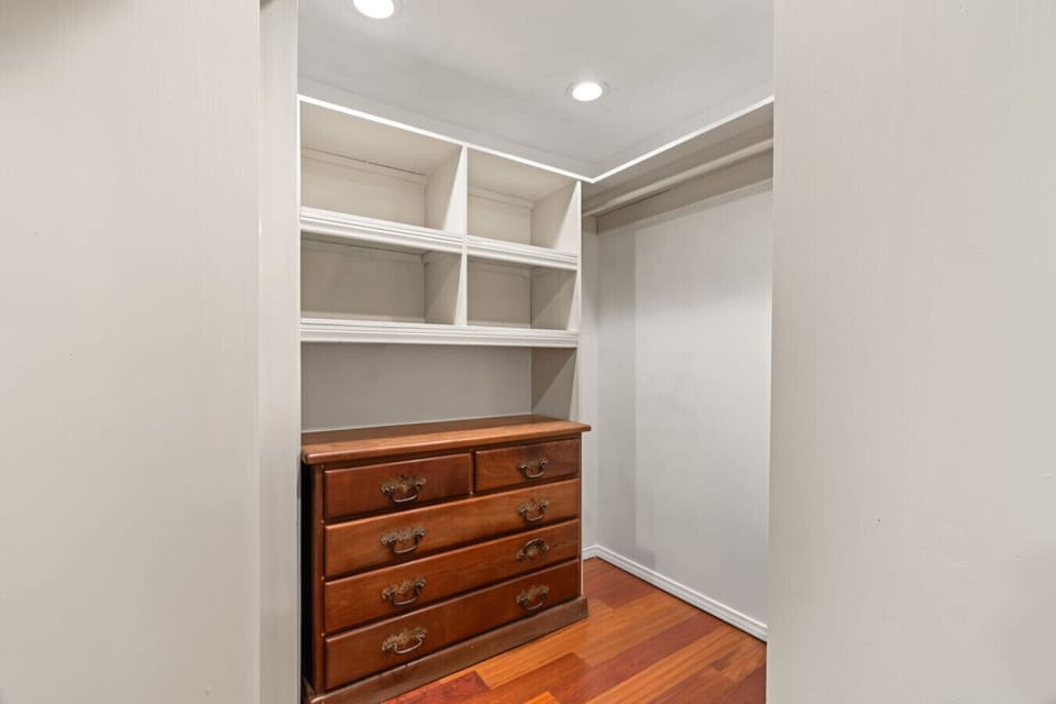Extra storage room w/ built-in shelves & dresser, ideal for longer stays or unpacking fully.