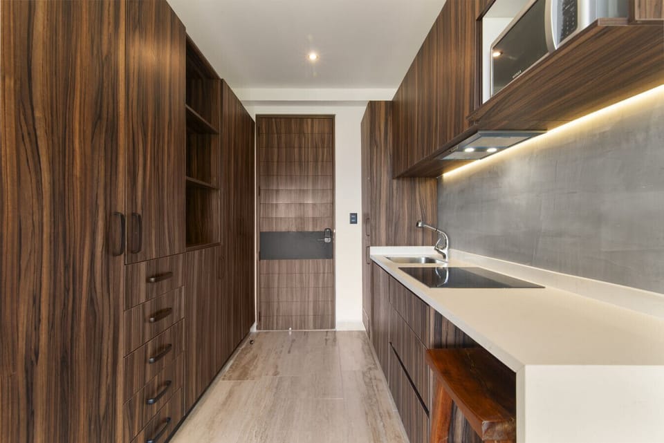 Modern kitchen with sunlight, wood accents & premium appliances.