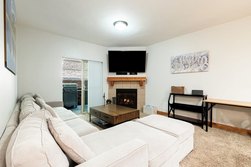 Living room with fireplace, smart TV and plenty of comfortable seating