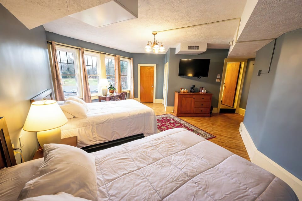 Stretch out with sunny windows, TV entertainment, and cozy bedding.