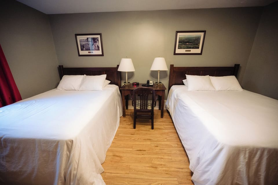 Drift off comfortably with bedside lamps and spacious room layout.