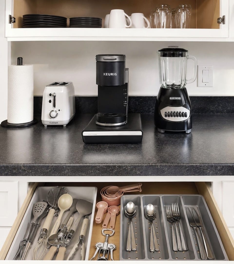 Kitchen coffee station with Keurig, toaster, blender, and everyday essentials