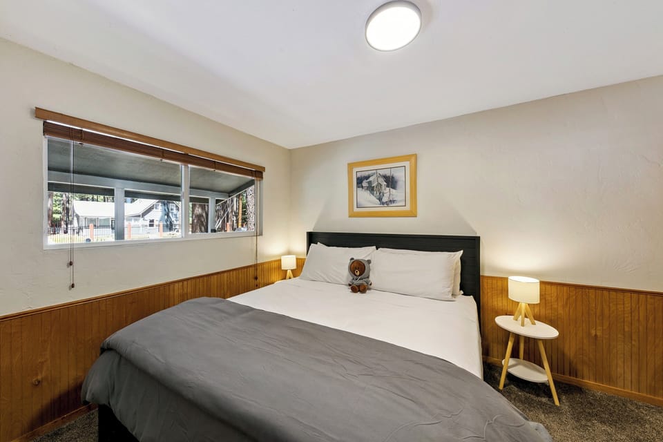 Drift off to dreamland in your cozy bedroom, where warm wood paneling and soft linens create the perfect retreat after your adventures.