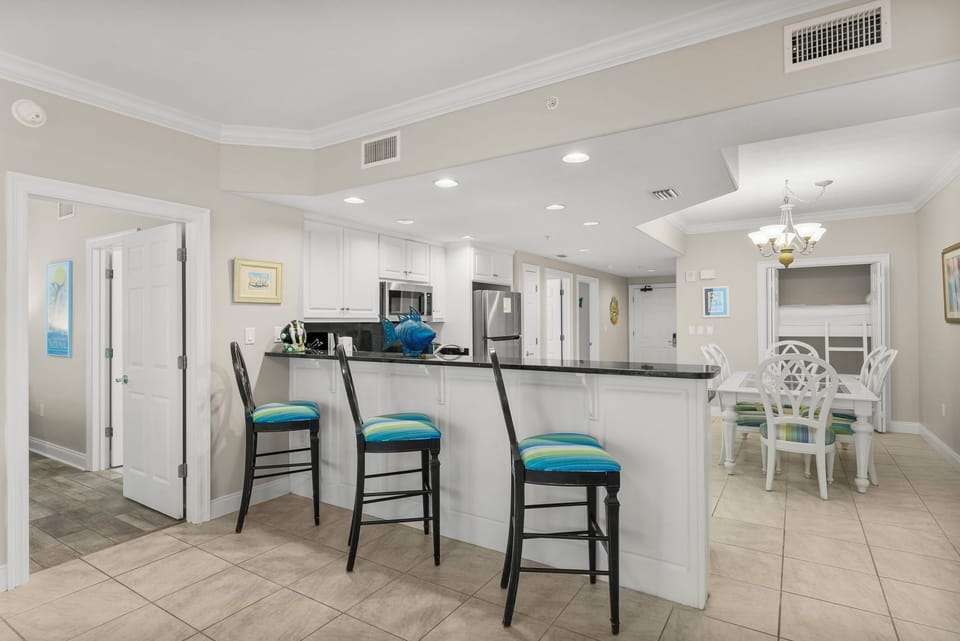 Modern kitchen with a breakfast bar and seating for three.