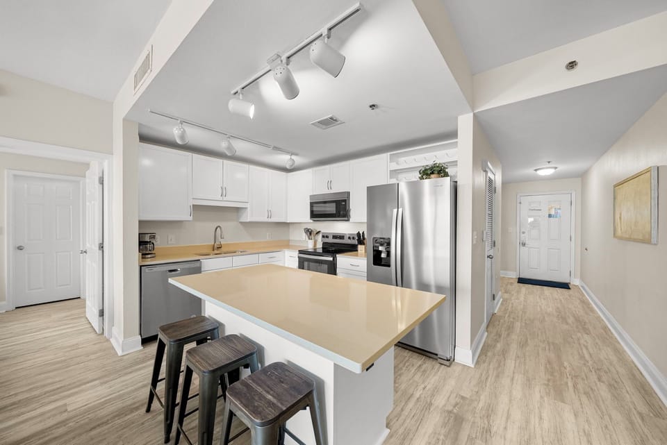 modern kitchen with stainless steel appliances and a central island with seating