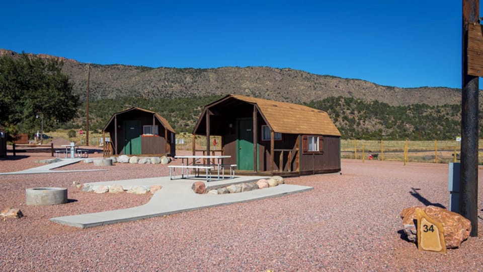 Picture the open, quiet grounds with neighboring cabins nearby.