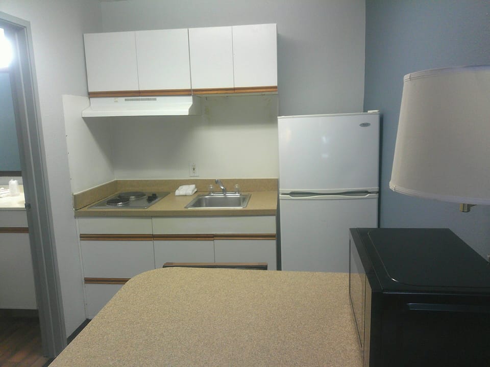 Full-size fridge, microwave, stovetop, dining tables