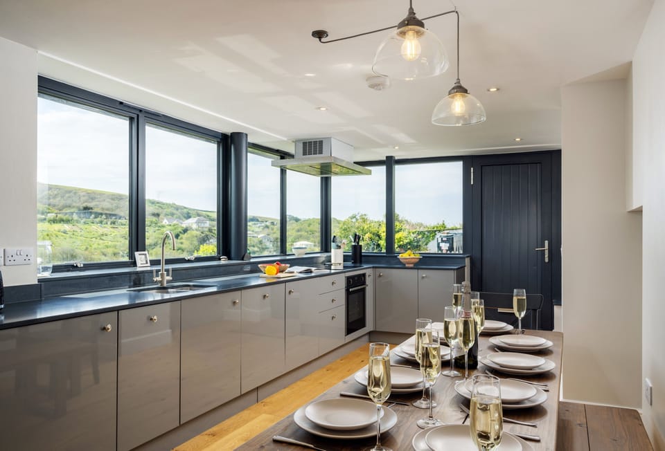 Pentreath, Crackington Haven:  Large dining table with benches invites leisurely family meals