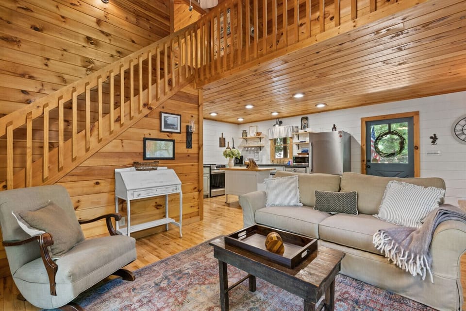 Inviting Cabin Interior 1 | Open Living and Dining Space with Stone Fireplace and Rustic Wood Finishes