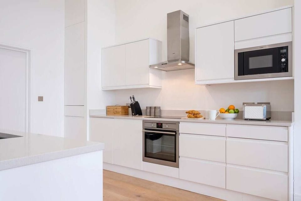 The modern streamlined kitchen comes fully equipped with everything you may need for your stay.