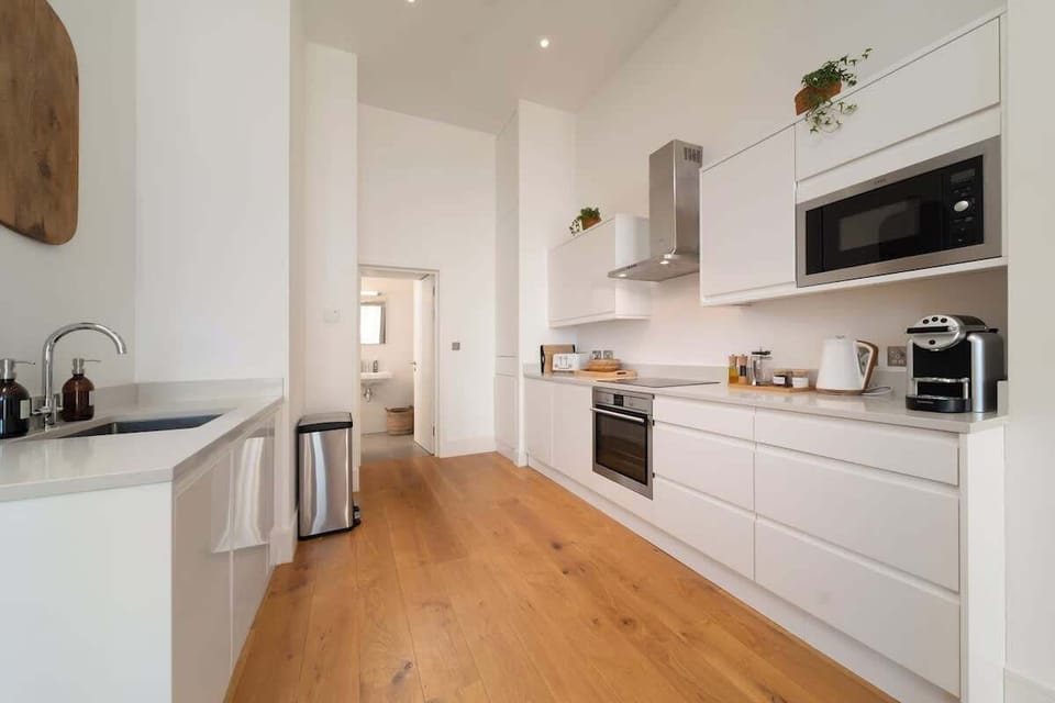 Experience a sleek, modern kitchen fully equipped with everything you need for a comfortable and effortless stay.