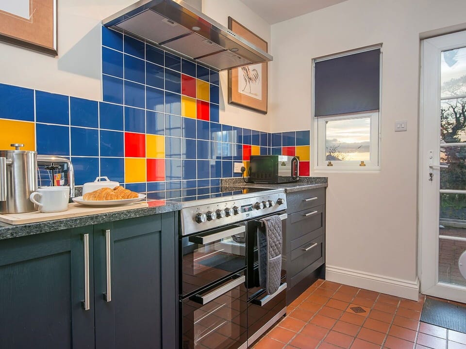 Kitchen, Flooring, Kitchen Appliance, Countertop, Major Appliance, Interior Design, Tile, Cabinetry, Floor, Kitchen Stove