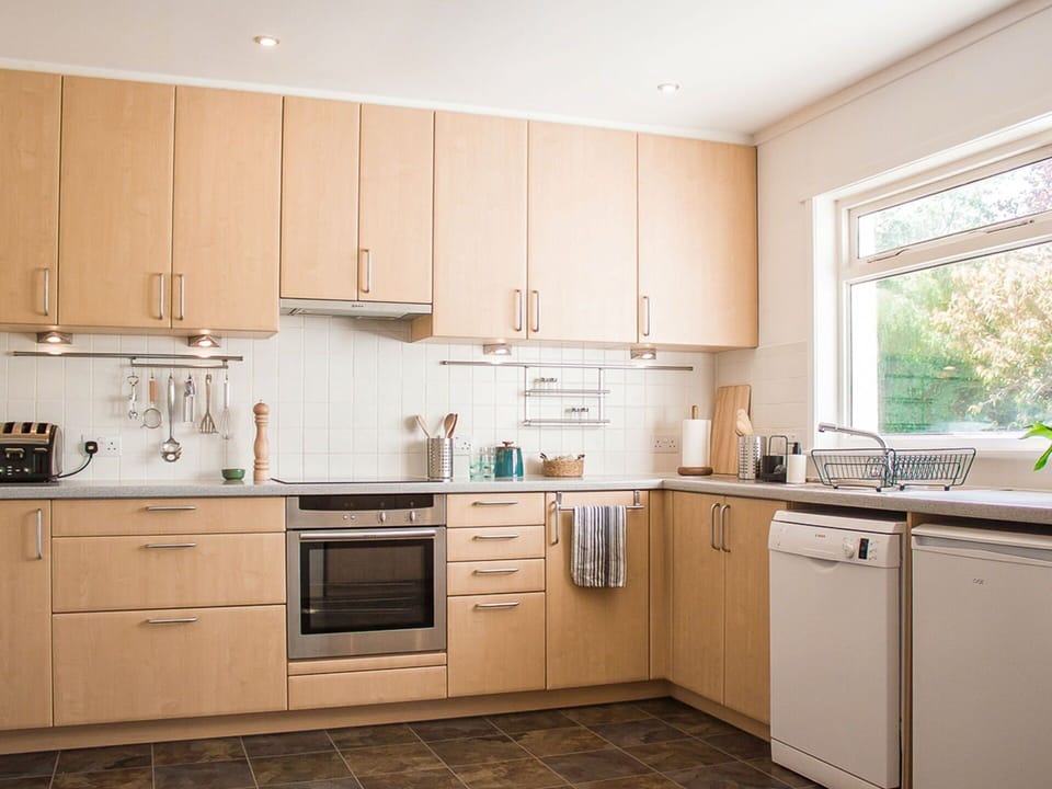 Kitchen Appliance, Kitchen, Cabinetry, Countertop, Major Appliance, Furniture, Flooring, Wood, Interior Design, Drawer