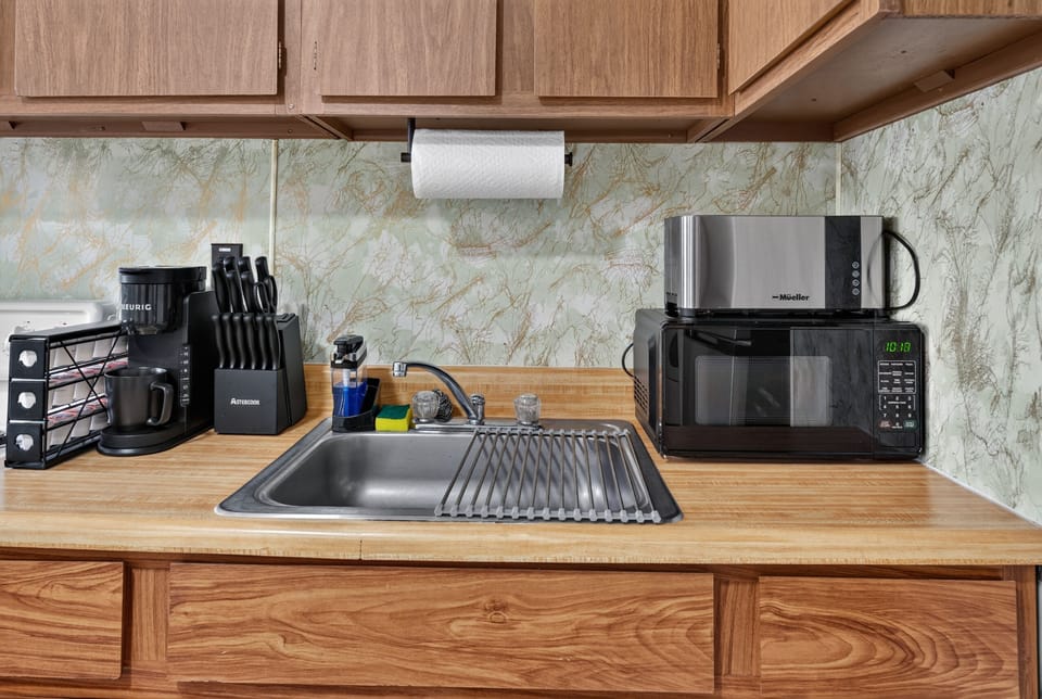 microwave, kitchen visible, indoor, coffee and or coffee maker, kitchen, stoveto