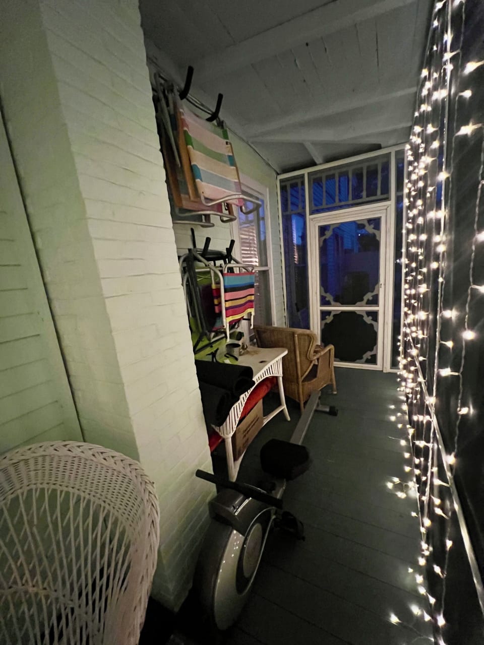Side of porch with beach chair storage and rowing machine