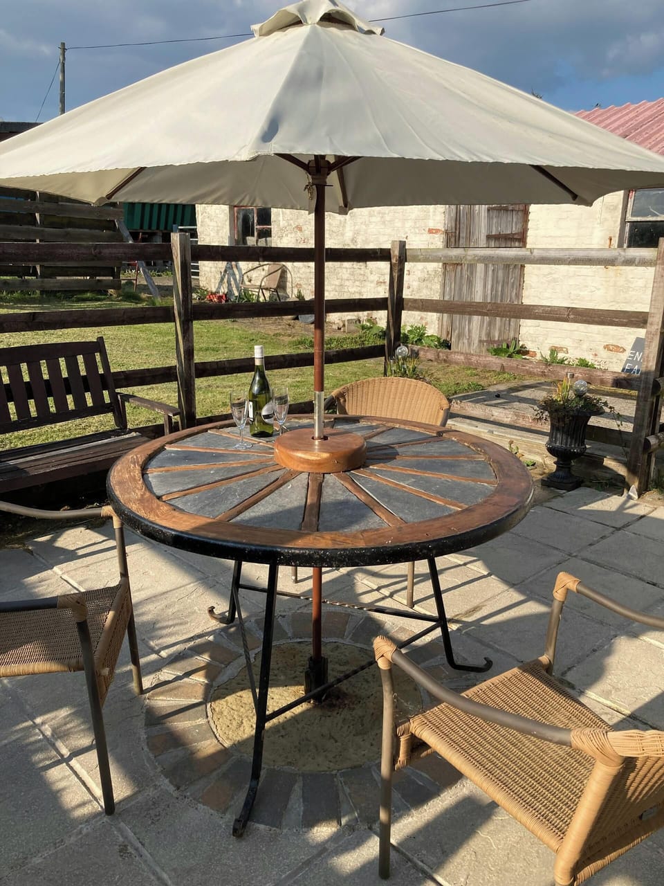 Circular table with parasol and four chairs