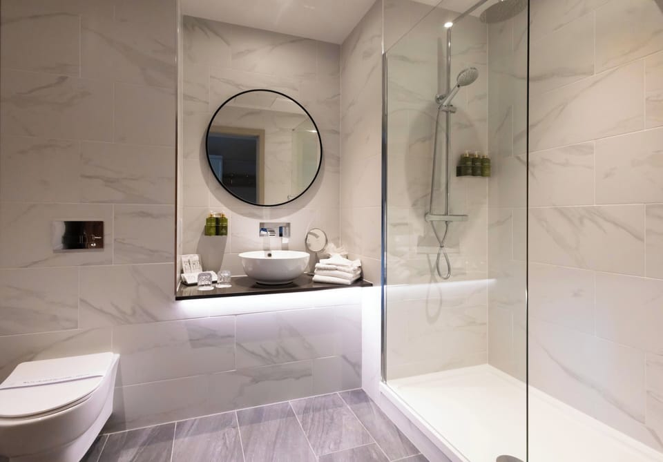 Shower, designer toiletries, hair dryer, bathrobes