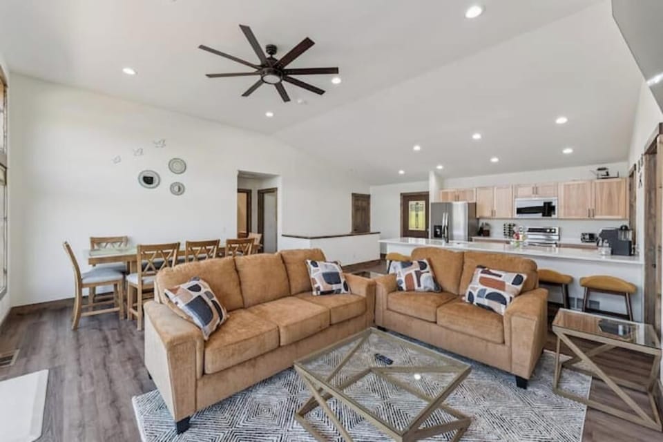 Upstairs main living area has dining table, couch, love seat, bar stools, kitche