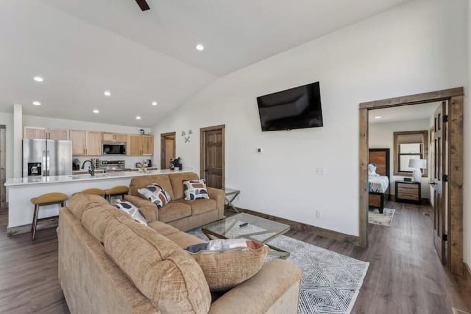 Upstairs main living area has dining table, couch, love seat, bar stools, kitche