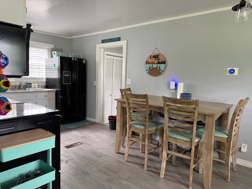 Dining area with seating for six once table is pulled away from wall.