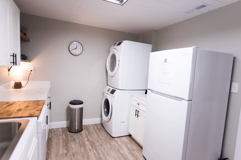 A fully stocked kitchen including washer, dryer, kitchen appliances, and spices.