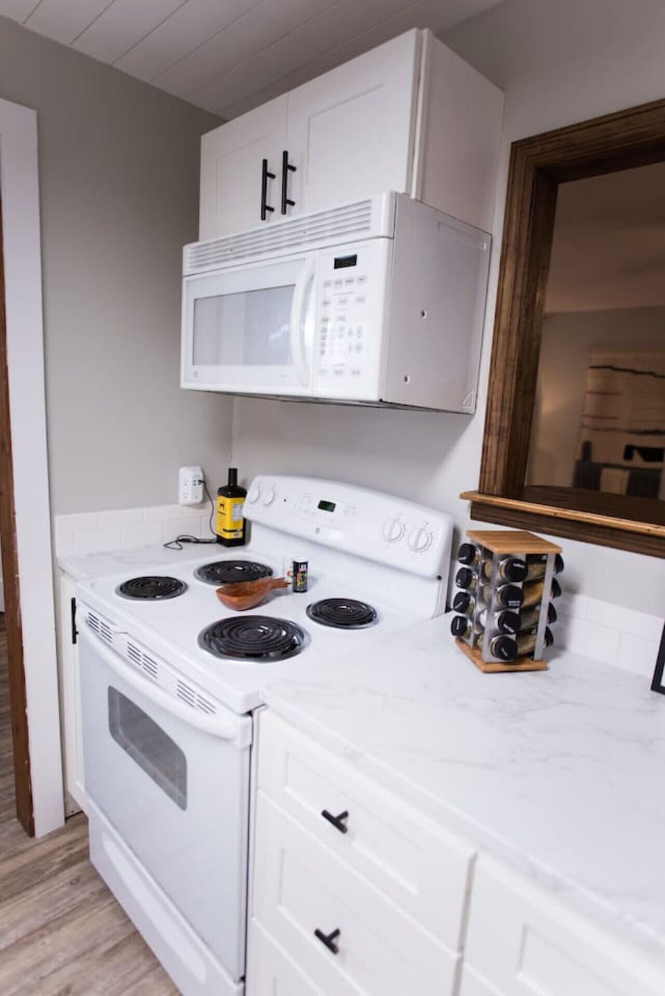 A fully stocked kitchen including washer, dryer, kitchen appliances, and spices.
