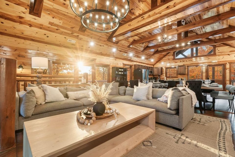 Spacious rustic living area with vaulted ceilings and natural light.