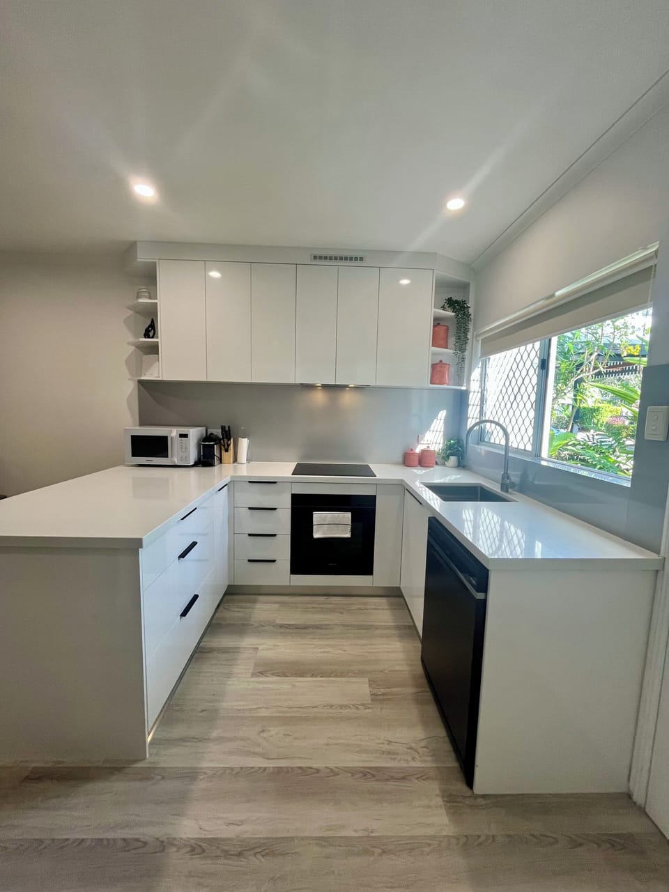Kitchen, European appliances, microwave, dishwasher, plates, glasses cutlery etc