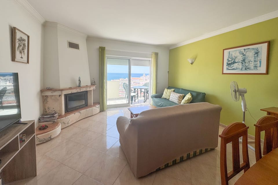 Living area with sofa%2C TV%2C and stunning views