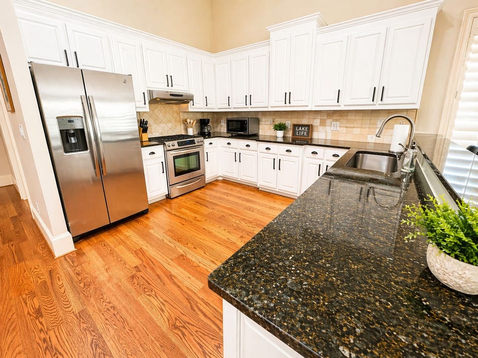 Cook, gather, and enjoy meals together in this open kitchen and dining space filled with natural light.