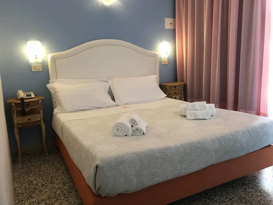 Double or Twin Room, Partial Sea View | In-room safe, desk, free WiFi, bed sheets