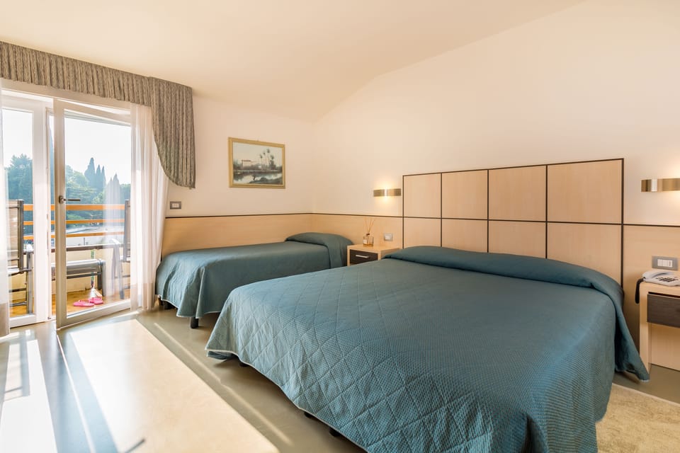 Triple Room, Pool View | Minibar, in-room safe, desk, free WiFi