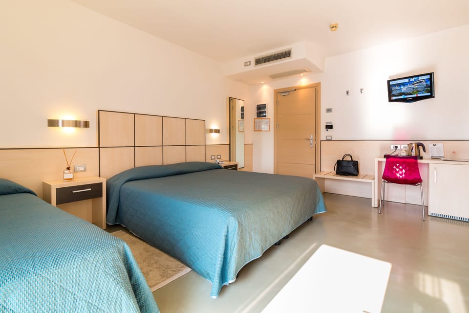 Triple Room, Pool View | Minibar, in-room safe, desk, free WiFi