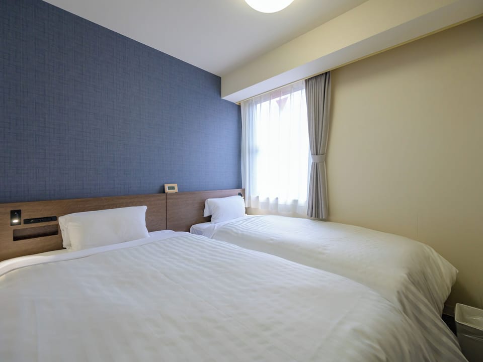Economy Twin Room | Desk, blackout drapes, iron/ironing board (on request), WiFi (free)