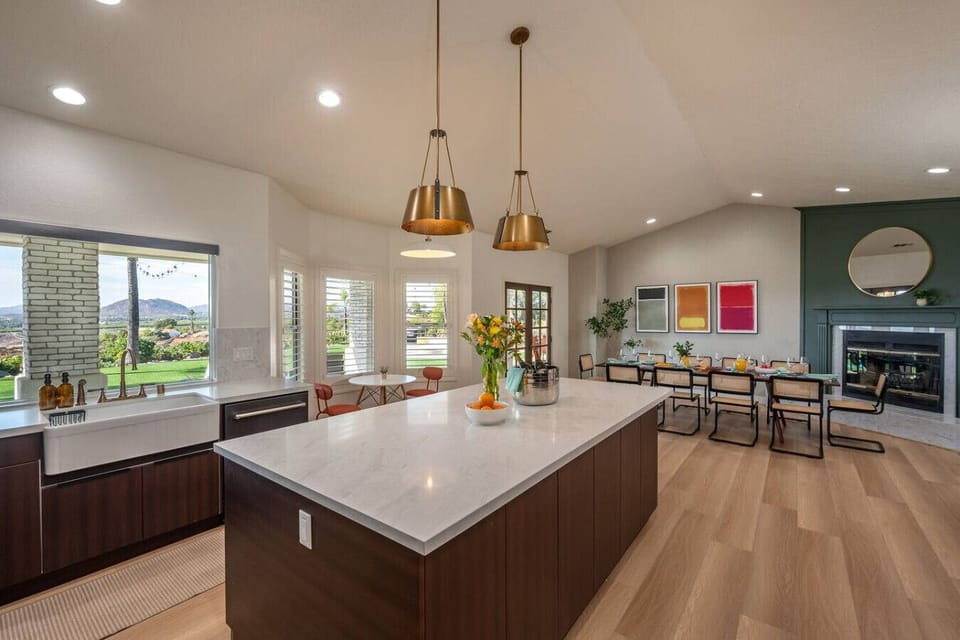 The kitchen is fully stocked and includes a cozy two-person nook table, two bar stools, and brand-new stainless steel appliances.