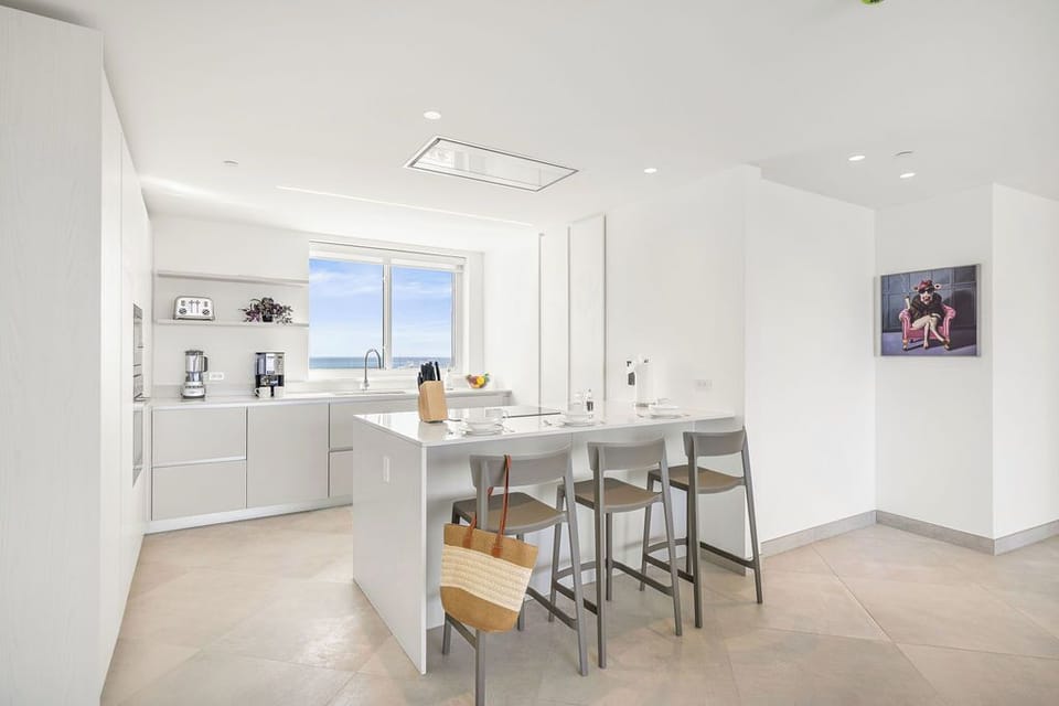 Your bright, modern kitchen awaits with sleek countertops, top appliances, and stunning sea views—perfect for preparing meals or gathering with loved ones over morning coffee.