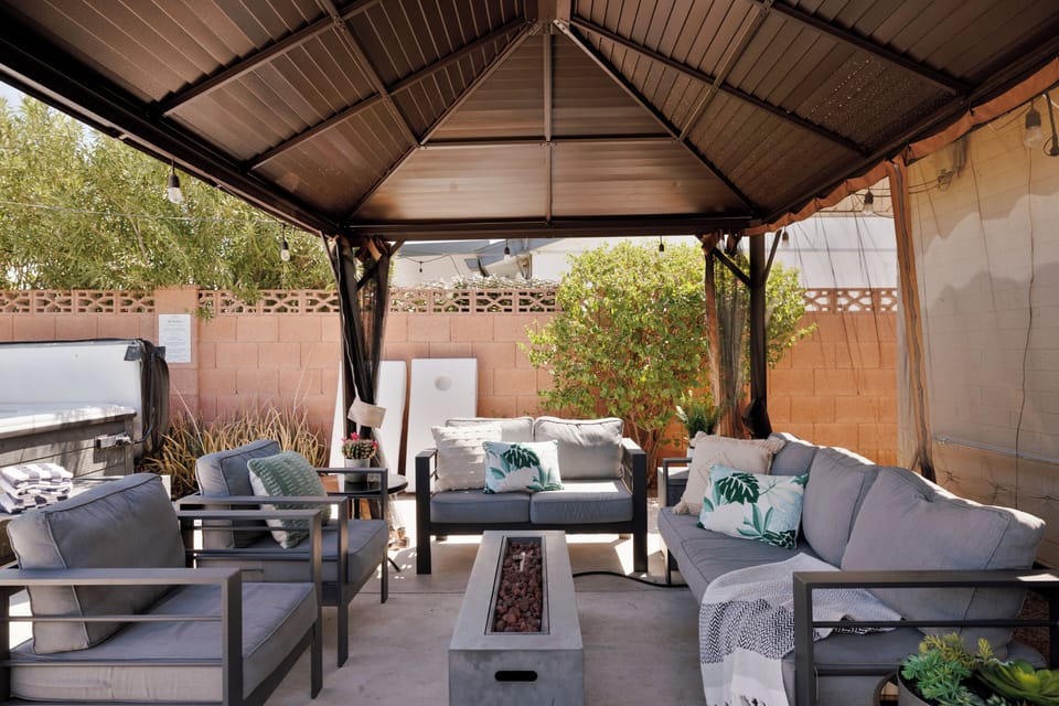 Dog-friendly backyard with covered outdoor lounge + fire pit.