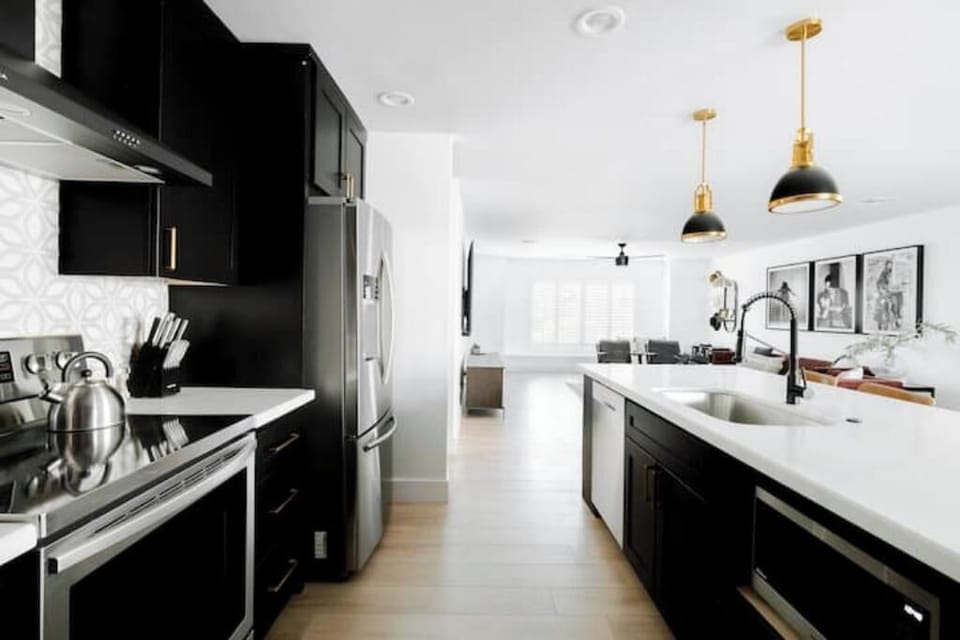 View of the kitchen appliances and open concept living area. 