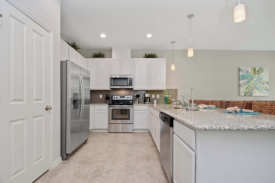 Chef-friendly and stylish: granite counters, stainless range and fridge, dishwasher, and lots of prep space-open to the living area for easy entertaining.