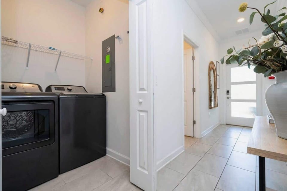 Travel made easy with a full laundry room featuring modern washer and dryer-ideal for keeping everything fresh during your stay.
