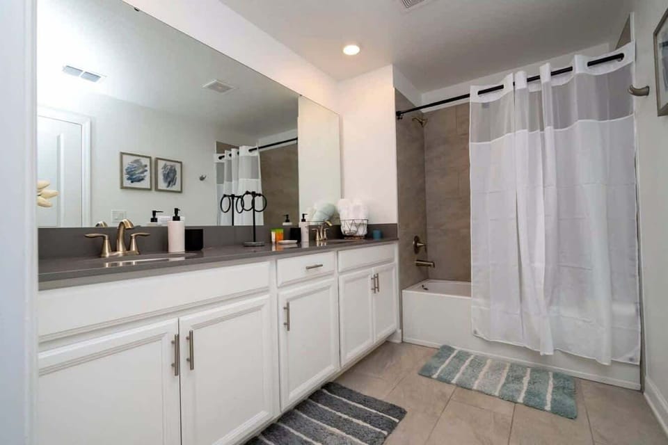 Pamper yourself in this spacious bathroom with double sinks, ample storage, and a relaxing tub-shower combo-perfect for unwinding after long days.