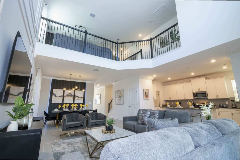 Experience open-concept luxury in this elegant space with a soaring loft, stylish furniture, and a modern kitchen perfect for unforgettable gatherings!