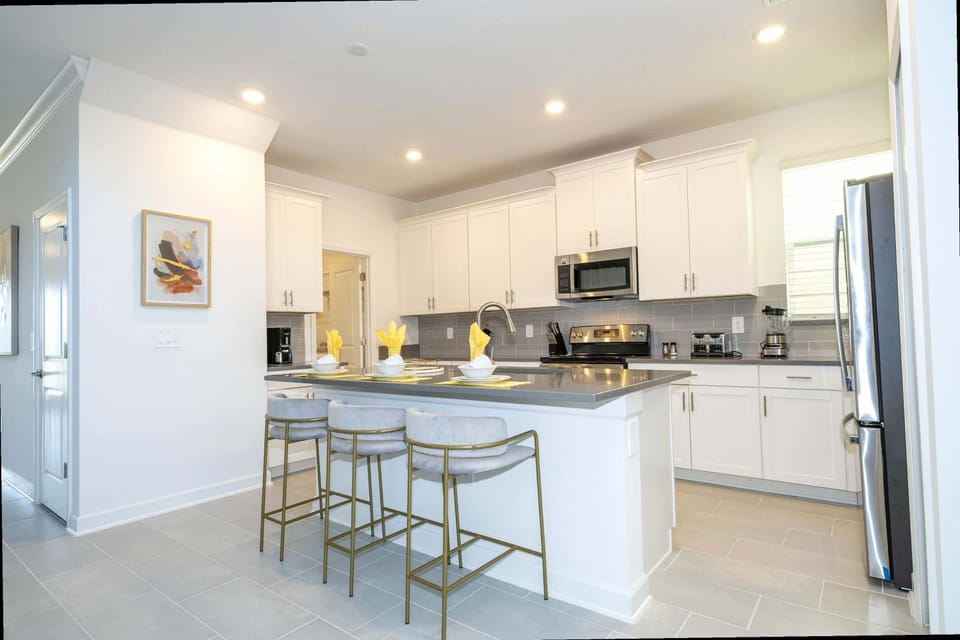 Whip up gourmet meals in this sleek kitchen with stainless appliances, a roomy island, and stylish bar seating for your whole crew!