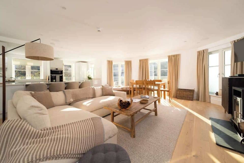 Experience the expansive elegance of our open-plan living room, which is built for comfort and easy relaxation in the centre of your stay.