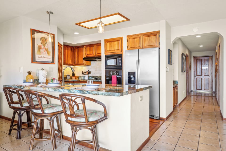 Stylish kitchen with bar seating - Cook in comfort in this beautifully appointed kitchen featuring granite countertops, stainless steel appliances, and island seating — perfect for casual meals or evening cocktails